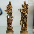 Set of two handcrafted brass statues inspired by Radha Krishna—elegant decorative couple showpiece for home décor and gifting.