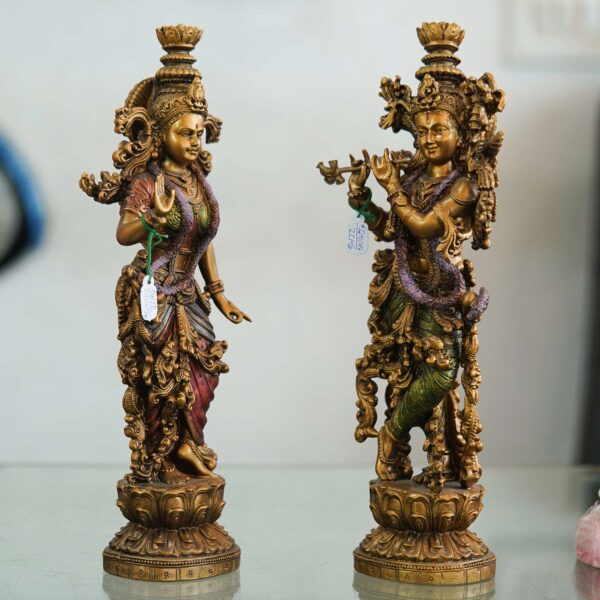 Set of two handcrafted brass statues inspired by Radha Krishna—elegant decorative couple showpiece for home décor and gifting. Set of two handcrafted brass statues inspired by Radha Krishna—elegant decorative couple showpiece for home décor and gifting.