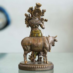 Brass Krishna with cow idol—flute playing Lord Krishna symbolizing love, purity, and harmony, ideal for home décor and gifting.