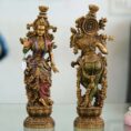 Set of two handcrafted brass statues inspired by Radha Krishna—elegant decorative couple showpiece for home décor and gifting.