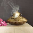 Elegant brass incense burner with a top opening for sticks and wide base for ashes—perfect for meditation, pooja, and home décor.