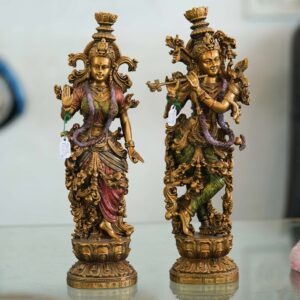 Set of two handcrafted brass statues inspired by Radha Krishna—elegant decorative couple showpiece for home décor and gifting.