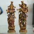 Set of two handcrafted brass statues inspired by Radha Krishna—elegant decorative couple showpiece for home décor and gifting.
