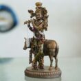 Brass Krishna with cow idol—flute playing Lord Krishna symbolizing love, purity, and harmony, ideal for home décor and gifting.
