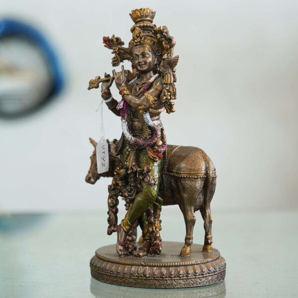 Brass Krishna with cow idol—flute playing Lord Krishna symbolizing love, purity, and harmony, ideal for home décor and gifting.