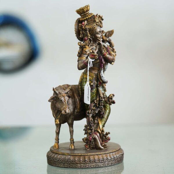 Brass Krishna with cow idol—flute playing Lord Krishna symbolizing love, purity, and harmony, ideal for home décor and gifting.